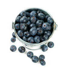 fresh blueberries in a bucket over white