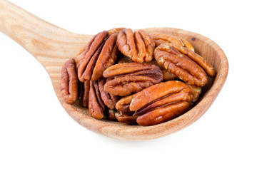 pecan nuts in a wooden spoon