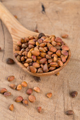 pine nuts on wooden surface