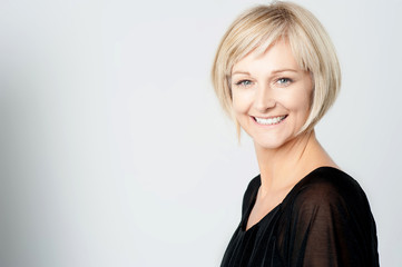 Smiling woman on a grey background