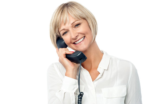 Smiling Woman Holding Phone Receiver