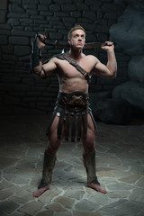 Obraz na płótnie Canvas Gladiator with sword posing