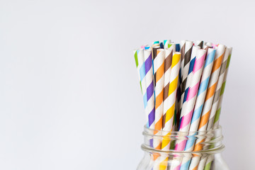 Colorful Paper Straws in Mason Jar on White Background