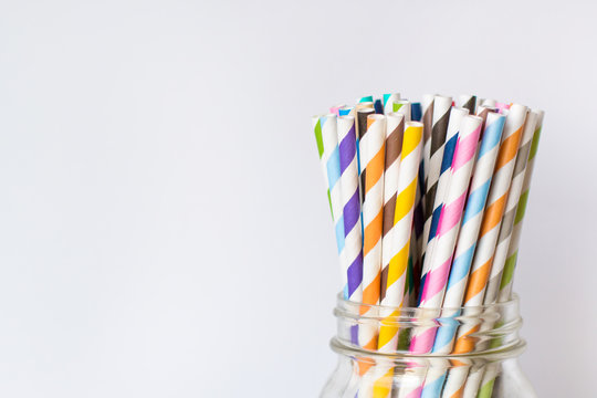 Colorful Paper Straws in Mason Jar on White Background