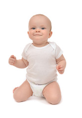Infant baby toddler sitting on her knees and happy smiling