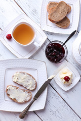 Fresh bread with cherry jam and homemade butter