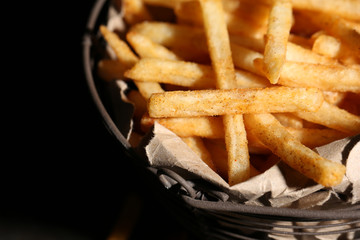 Tasty french fries in metal basket