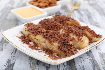 Sweetened fried banana on plate, close-up