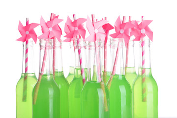 Bottles of drink with straw isolated on white