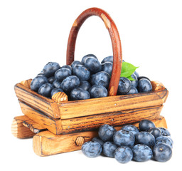Delicious blueberries in wooden basket isolated on white