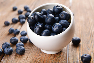Delicious blueberries in bowl on table close-up