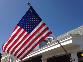 American flag under blue sky