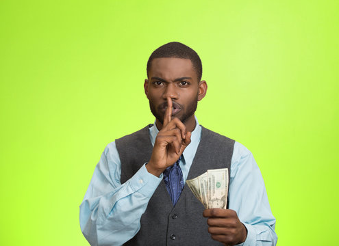 Bribery man with dollar, quiet gesture, green background 