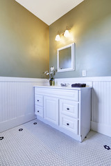 Bathroom corner with white vanity cabinet