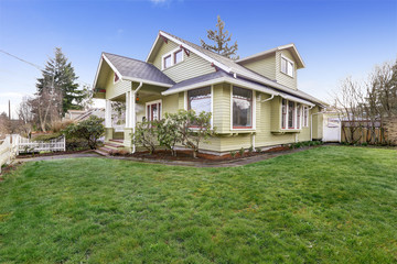 Light green house exterior with column porch