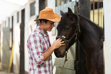 horse breeder comforting a horse