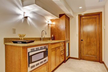 Kitchen cabinets with steel microwave.