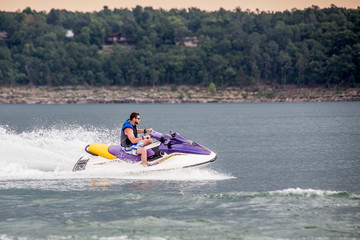 Young Man piloting a personal water craft