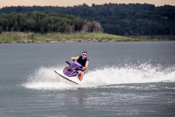 Young Man piloting a personal water craft