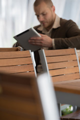 Businessman using tablet computer cafe