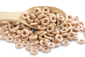 Wooden spoon with cereal rings on white background