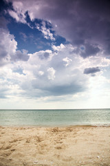 Fototapeta na wymiar Sea sand and clouds