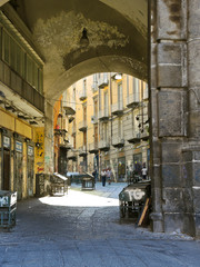 Fototapeta na wymiar arch and street in old city of Naples, Italy