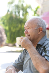 happy grandfather drinking morning coffee