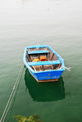 Fototapeta na wymiar blue boat in water on Bay of Biscay