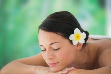 Obraz na płótnie Canvas Beautiful brunette relaxing on massage table
