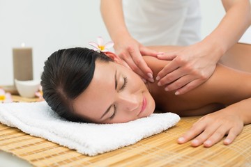 Peaceful brunette enjoying a shoulder massage
