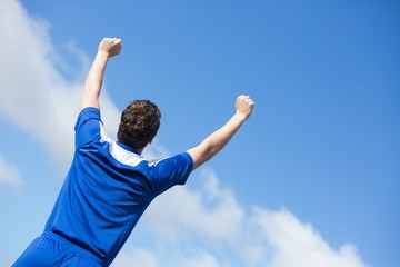 Football player in blue cheering