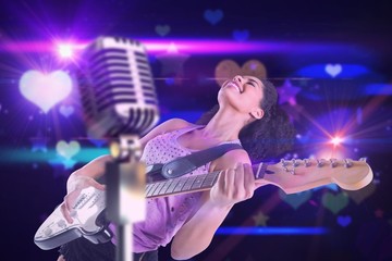 Fototapeta premium Composite image of pretty girl playing guitar