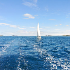 Fototapeta na wymiar white sail yacht in blue Adriatic sea