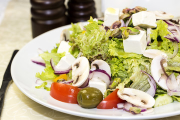 Greek salad on a white background in the restaurant