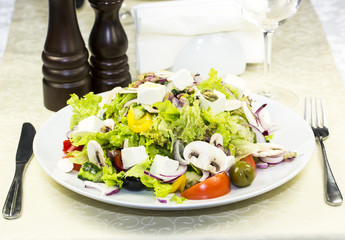 Greek salad on a white background in the restaurant