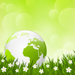 Earth globe on green grass