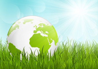 Earth globe on green grass