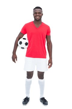 Football player in red jersey holding ball