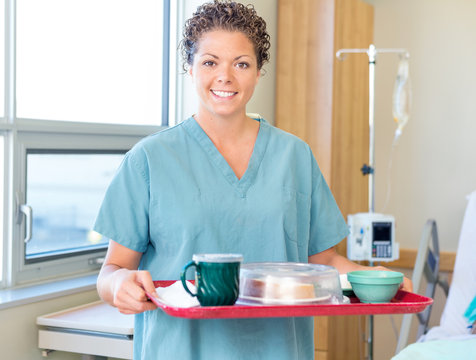 Nurse Holding Breakfast Tray In Hospital Room