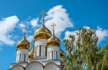Fototapeta na wymiar White orthodox church with gold domes