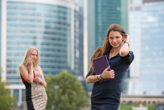 Two Young Businesswoman Near Skyscrapers