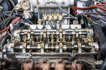 Close up of engine parts headers pistons block