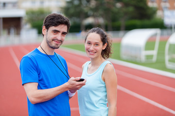 Sport coach training a young attractive woman