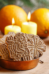 Bowl of christmas cookies among aromatic oranges and yellow cand