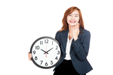 Happy Asian businesswoman laughing with a clock