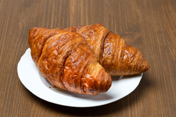 fresh croissants on a plate