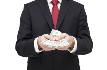 Businessman holding dollars. Clipping path included.
