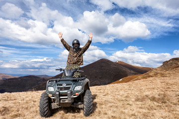 male rider on ATV at mountain top