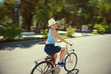 Happy young woman cycling
